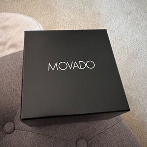 EUC black with signature concave at 12, women’s Movado watch